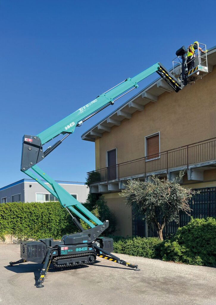 IM R 57 / 18 SA Pro tracked spider lift reaching over a rooftop